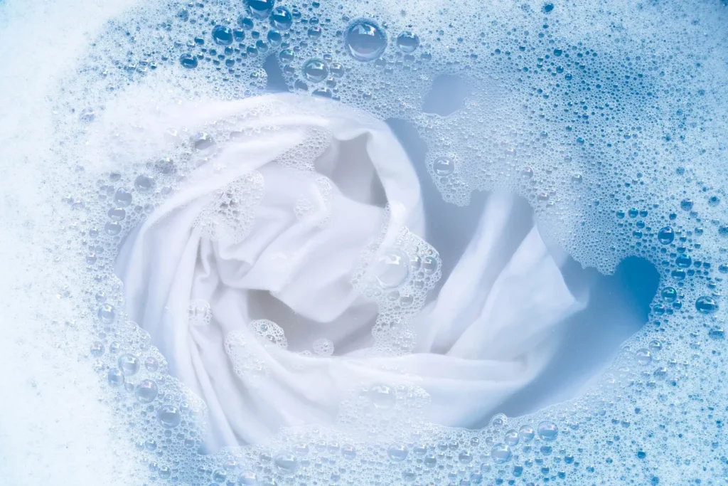 Washing a white shirt in a detergent solution